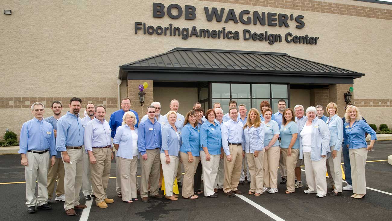 bob wagner's flooring america team photo in front of store