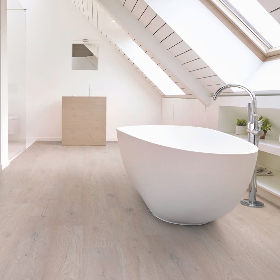 soaker to in bathroom with light wood plank flooring