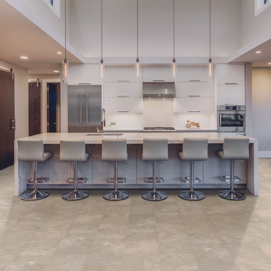 stone look flooring in gray and white kitchen with kitchen island and bar seating